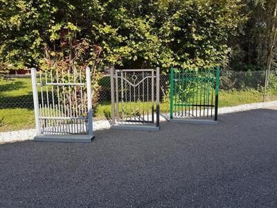 Drei kleine Metalltore stehen in einer Reihe nebeneinander