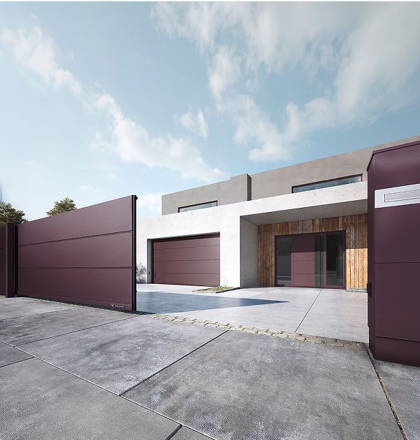 Modernes Haus mit einem weinrotem Tor vor einem klaren blauen Himmel